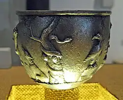 A serpent coiled around a tree confronts an eagle.