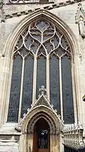 The five-light window with reticulated ogee arches above the doorway of the north aisle