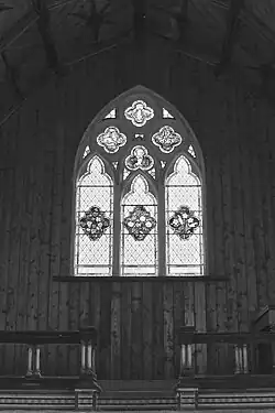 An interior view of the altar and stained glass window