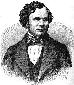 A dark-haired gentleman in a dark suit