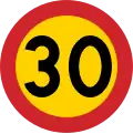 Swedish 30 km/h speed limit – the yellow background provides a contrast in case snow covers the background against which one perceives the road sign.[39]