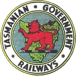 Logo of the Tasmanian Government Railways, showing the Tasmanian Red Lion on a Map of Tasmania, surrounded by Tasmanian Government Railways text.