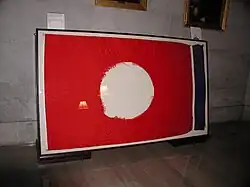 The Tennessee state flag which flew over the Capitol during the Tornado outbreak of April 15–16, 1998. The middle emblem was ripped out during the storm. This flag is on display at the Tennessee State Capitol.