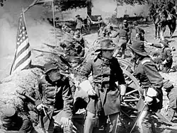 Black and white film still showing Civil War era soldiers and civilians