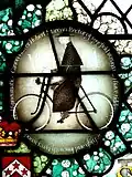 Stained glass roundel of Canon Walter Herbert Marcon on his Bicycle in the church