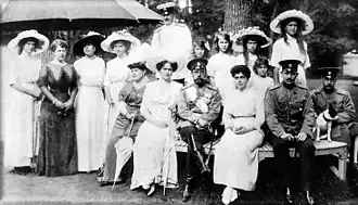 Black and white photograph showing a group of seven women, four men and five girls.