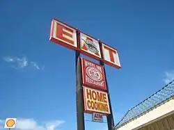 Restaurant sign reading "EAT" and "Home Cooking"