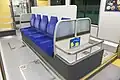 Semi-cross seating with long seats placed on center, facing both sides of windows. Tokyo Monorail 10000 series.