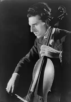 White man playing the cello, seen semi-profile