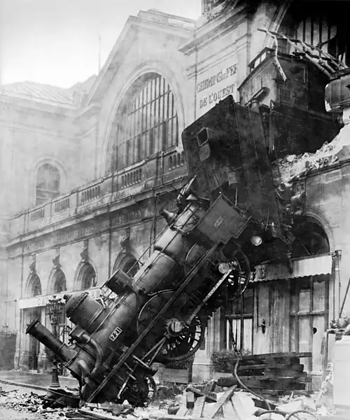 Image 15 1895 train wreck, Gare Montparnasse Photo credit: Studio Lévy and Sons On October 22, 1895, the Granville–Paris Express train overran the buffer stop at Gare Montparnasse station. The engine careened across almost 30 metres (100 feet) of the station concourse, crashed through a 60 centimetre thick wall, shot across a terrace and sailed out of the station, plummeting onto the Place de Rennes 10 metres (30 feet) below where it stood on its nose. While all of the passengers on board the train survived, one woman on the street below was killed by falling masonry. More featured pictures