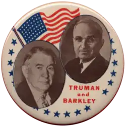 A campaign button with portraits of Harry S. Truman and Alben W. Barkley. The American flag can also be seen. "Truman and Barkley" is written below the portraits.