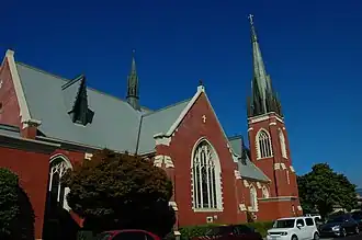 A color photograph of a brick building, a church