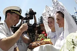 US Naval officer Jonathan Greenert takes part in a bread and salt ceremony after arriving in Vladivostok, Russia, July 3, 2006.