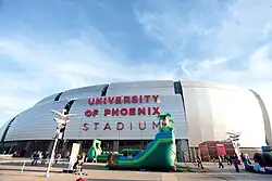 Exterior of stadium, with a bouncehouse in front of it
