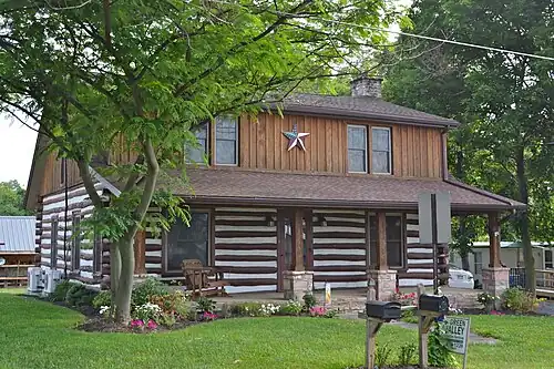 A log house with a barn star