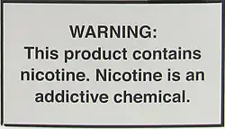 A nicotine warning statement for vaping products sold in the US. It graphic states: WARNING: This product contains nicotine. Nicotine is an addictive chemical.