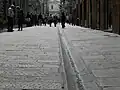 The new paving of Via San Lorenzo, one of the main streets in the historic center of Genoa, made in 2000/2001, on the occasion of the G8.[216] The street underwent major changes in the mid-19th century as part of the construction of the second part of the Carlo Alberto carriageway, including the retreat of the facades of some buildings.[160][161]