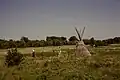 Visitors taking photos next to a tipi