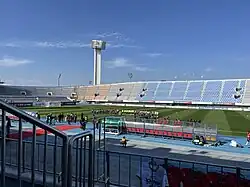 Teams and officials line up on a football pitch ready for a match.