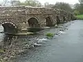 The 16th-century White Mill Bridge crossing the River Stour