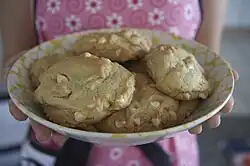 A bowl of roughly shaped brown biscuits, studded with white pieces.