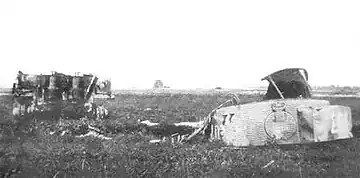 A photograph of a wrecked Tiger tank in a field