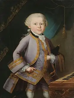 a child (Mozart) in formal embroidered 18th century costume, left hand thrust into his waistcoat. He looks directly out of the picture, although his body is turned towards the right.