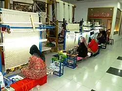 Women weaving silk. Kashgar