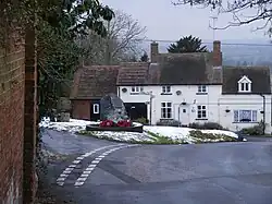 Location of the War Memorial, with former blacksmith's house on far side of the green.