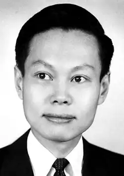 Black-and-white photograph of Yang Chen-Ning at 35 years-old, a young Chinese man with short, dark hair wearing a morning suit.