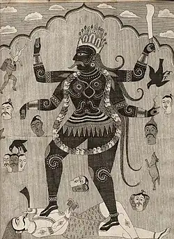 Representation of a female monstrous figure with four arms holding human heads.