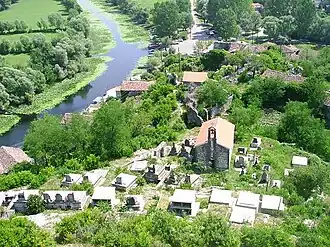 The village church and graveyard under the castle